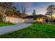 Well-manicured lawn and landscaping highlight the property's curb appeal, with a circular driveway leading to a three-car garage at 4009 Ballovista Rd, Johns Island, SC 29455