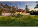 Luxury home exterior with large lawn, covered veranda, and three car garage at 4009 Ballovista Rd, Johns Island, SC 29455