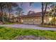 Sprawling single story home with tan exterior, multiple garage doors, and a circular driveway at 4009 Ballovista Rd, Johns Island, SC 29455