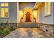 Inviting front entrance of a home featuring stone steps, stately wooden front door and manicured landscaping at 4009 Ballovista Rd, Johns Island, SC 29455