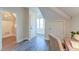 Hallway with hardwood floors, white trim, and doors leading to various rooms at 4009 Ballovista Rd, Johns Island, SC 29455