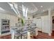 Stylish kitchen featuring white cabinets, marble counters and backsplash, plus an island with seating at 4009 Ballovista Rd, Johns Island, SC 29455