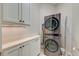 Laundry room featuring a stacked washer and dryer unit with cabinets and counter space at 4009 Ballovista Rd, Johns Island, SC 29455