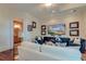 Inviting living room with white sofa, chairs, a large TV and wood floors offering relaxation and entertainment at 4009 Ballovista Rd, Johns Island, SC 29455