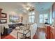 Cozy living room with a white sofa, armchairs, large TV, ceiling fan, and hardwood floors at 4009 Ballovista Rd, Johns Island, SC 29455