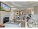 Cozy living room with a fireplace, hardwood floors, and an open view of the kitchen and bar area at 4009 Ballovista Rd, Johns Island, SC 29455