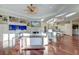 Open-concept living room with a built-in aquarium, fireplace, and hardwood floors flowing into the kitchen at 4009 Ballovista Rd, Johns Island, SC 29455