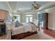 Luxurious main bedroom featuring hardwood floors, a tray ceiling, and a ceiling fan, exuding comfort and sophistication at 4009 Ballovista Rd, Johns Island, SC 29455