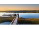 Picturesque view of a pier with a gazebo at the end, extending into calm waters at sunset at 4009 Ballovista Rd, Johns Island, SC 29455