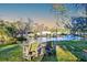 Picturesque backyard pond with fountain, lush greenery, and seating area, creating a peaceful and inviting atmosphere at 4009 Ballovista Rd, Johns Island, SC 29455