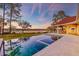 Stunning pool with integrated spa overlooking tranquil marsh views and captivating sunset skies at 4009 Ballovista Rd, Johns Island, SC 29455