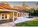 Outdoor living space featuring a covered patio, comfortable seating, and a refreshing pool with views of the lush backyard at 4009 Ballovista Rd, Johns Island, SC 29455