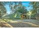 Charming shed with screened porch, lush greenery, providing a functional and aesthetic addition to the property at 4009 Ballovista Rd, Johns Island, SC 29455