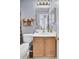 Bright bathroom with a white countertop vanity, wood cabinets, and an updated lighting fixture above the mirror at 402 Pine Bluff Dr, Summerville, SC 29483