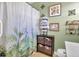 Bathroom with shower/tub, shower curtain, shelving for towels, and artwork on the walls at 402 Pine Bluff Dr, Summerville, SC 29483
