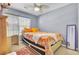 Bright bedroom with a colorful bed, a desk, and a mirror with a neutral carpet at 402 Pine Bluff Dr, Summerville, SC 29483