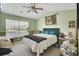 Bedroom features neutral carpet, ceiling fan, green walls, and a large window for natural light at 402 Pine Bluff Dr, Summerville, SC 29483