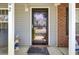 Inviting front entrance featuring a secure black screen door, brick accents, and a charming welcome mat at 402 Pine Bluff Dr, Summerville, SC 29483
