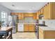 A full kitchen features stainless steel appliances, light wood cabinets, and granite countertops at 402 Pine Bluff Dr, Summerville, SC 29483