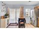 Kitchen with island table, stainless steel refrigerator, sliding glass doors, and hard wood flooring at 402 Pine Bluff Dr, Summerville, SC 29483