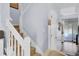 View of the carpeted staircase with white banister leading to the upper level of the home at 402 Pine Bluff Dr, Summerville, SC 29483