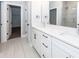 Bathroom features dual sink vanity with white cabinets and a doorway to a closet at 413 Renau Blvd, Summerville, SC 29483
