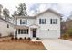 Charming two-story home with white siding, dark shutters, and a well-manicured lawn at 413 Renau Blvd, Summerville, SC 29483