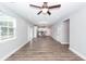 Bright, open-concept living room with hardwood floors flowing into a modern kitchen with stainless appliances at 413 Renau Blvd, Summerville, SC 29483
