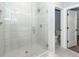 Walk-in shower featuring white tiling, glass door, and modern fixtures at 413 Renau Blvd, Summerville, SC 29483