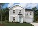 Charming two-story home with light gray siding, well-manicured lawn and attached two-car garage at 4159 Rising Tide Dr, Summerville, SC 29485