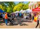 A vibrant outdoor market scene with various vendors and a diverse crowd of shoppers at 4159 Rising Tide Dr, Summerville, SC 29485