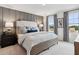 Comfortable primary bedroom with large windows, tray ceiling, and neutral decor at 4183 Rising Tide Dr, Summerville, SC 29485