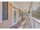 Inviting front porch with a wicker chair, ceiling fan and front door at 4462 Francis Yonge Way, Hollywood, SC 29449