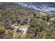 An aerial view of a lushly wooded property with several homes near waterfront, offering privacy and beautiful scenery at 4462 Francis Yonge Way, Hollywood, SC 29449