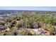 A high aerial view of the wooded community with lake and marsh views surrounding the property at 4462 Francis Yonge Way, Hollywood, SC 29449