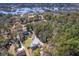 An aerial view shows a quiet neighborhood with marsh views, docks, and mature landscaping at 4462 Francis Yonge Way, Hollywood, SC 29449