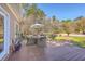 Relaxing outdoor deck with dining area, BBQ grill, and views of the landscaped backyard at 4462 Francis Yonge Way, Hollywood, SC 29449