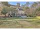 Expansive backyard featuring a deck with outdoor seating and a grill surrounded by lush foliage at 4462 Francis Yonge Way, Hollywood, SC 29449