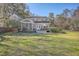 The spacious backyard features a screened in porch, wooden deck, and lush green grass at 4462 Francis Yonge Way, Hollywood, SC 29449