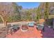 Inviting backyard patio with comfortable seating around a brick fire pit and hammock at 4462 Francis Yonge Way, Hollywood, SC 29449