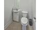 Small, but well kept bathroom has toilet, sink with cabinet, and dark metal trash can at 4462 Francis Yonge Way, Hollywood, SC 29449