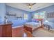 Charming bedroom featuring blue walls, hardwood floors, a ceiling fan, and natural light at 4462 Francis Yonge Way, Hollywood, SC 29449