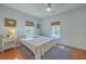 Bright bedroom with hardwood floors, a ceiling fan, and two windows with natural light at 4462 Francis Yonge Way, Hollywood, SC 29449