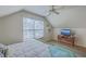 A bright bedroom features a ceiling fan, a window with blinds, and a comfortable bed at 4462 Francis Yonge Way, Hollywood, SC 29449