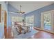 Bright dining room with large windows, wood floors, a ceiling fan, and a spacious wooden table with bench seating at 4462 Francis Yonge Way, Hollywood, SC 29449