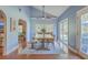 Inviting dining room with vaulted ceiling, ceiling fan, and sliding door to a patio at 4462 Francis Yonge Way, Hollywood, SC 29449