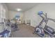 Spacious exercise room equipped with machines, mirrored wall, and mounted TV at 4462 Francis Yonge Way, Hollywood, SC 29449