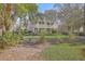 Two-story home features a double porch, manicured lawn, and mature landscaping at 4462 Francis Yonge Way, Hollywood, SC 29449