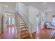 Welcoming foyer with hardwood floors, staircase, and a view into adjacent living spaces at 4462 Francis Yonge Way, Hollywood, SC 29449