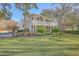 Charming two-story home with a double porch, green lawn and inviting curb appeal at 4462 Francis Yonge Way, Hollywood, SC 29449